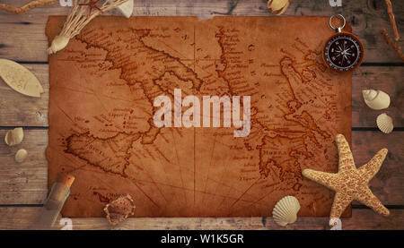 A piece of an old marine map on a wooden table surrounded by sea things, compass and an old bottle. Stock Photo
