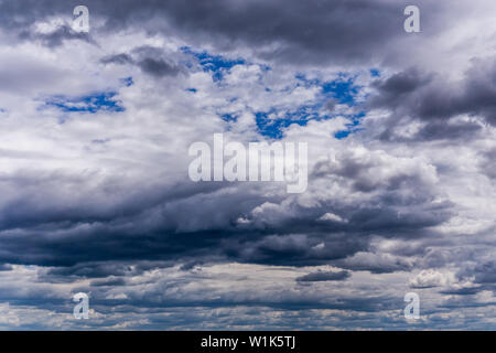 gray incoming near storm clouds daylight backdrop. Stock Photo