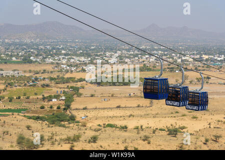 Pushkar, India - February 06, 2019: Hanging cabins of the ropeway to Savitri Mata temple on Ratnagiri hills in Pushkar. Rajasthan Stock Photo