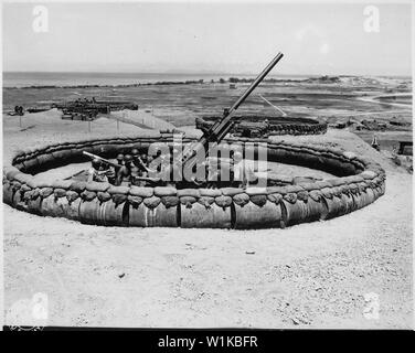 View of #4 90mm Anti-aircraft artillery gun emplacement with crew in pit. D Battery, 98th Anti-aircraft artillery Gun Battalion, 137th Anti-aircraft artillery Group Okinawa; General notes:  Use War and Conflict Number 1225 when ordering a reproduction or requesting information about this image. Stock Photo