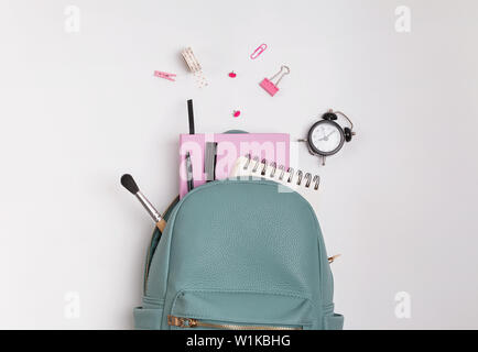 Student's backpack with different stationery and study supplies on the white background, top view. Back to school concept. Stock Photo
