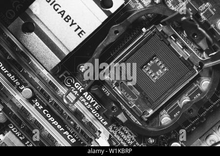 Maykop, Russia - September 17, 2016: empty socket Intel CPU on Gigabit motherboard, top view close-up, black and white photo Stock Photo