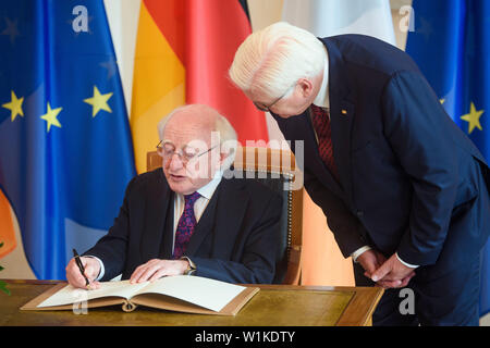 Berlin, Germany. 03rd July, 2019. Michael D. Higgins (l), President of Ireland, joins Frank-Walter Steinmeier (SPD), Federal President, on a state visit to Bellevue Castle and signs the guest book. Credit: Gregor Fischer/dpa/Alamy Live News Stock Photo