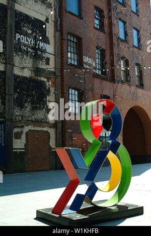 London, United Kingdom - July 14 2005:   A modern art sculpture of an Ampersand outside some old warehouses Stock Photo