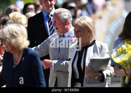 The Duchess of Cornwall (left) and the Prince of Wales arrive at Victoria Park in Swansea, Wales, to mark 50 years since his investiture as Prince of Wales. Stock Photo