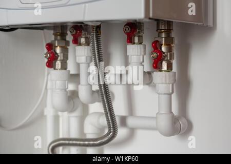 Description: wiring of plastic pipes to the water heater in the apartment Stock Photo