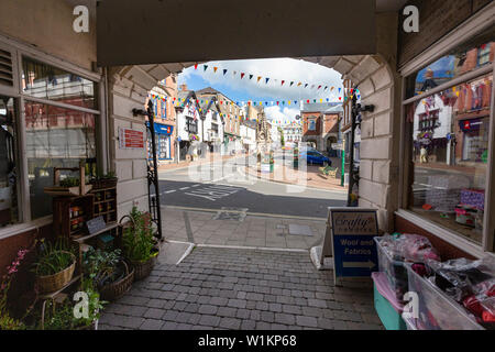 View of The Square, (Town Centre), Town Hall and Clock Tower from the Main Entrance to the Great Torrington Pannier Market. Stock Photo