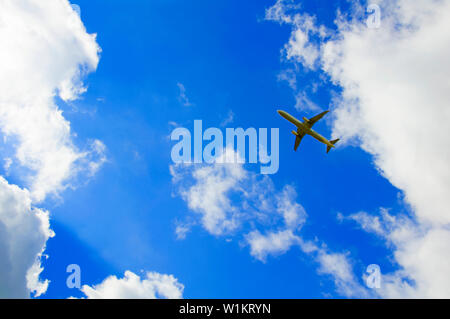 Big passenger plane in the blue cloudy sky, summer time Stock Photo