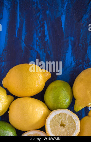 Lemon and limes on a blue background Stock Photo