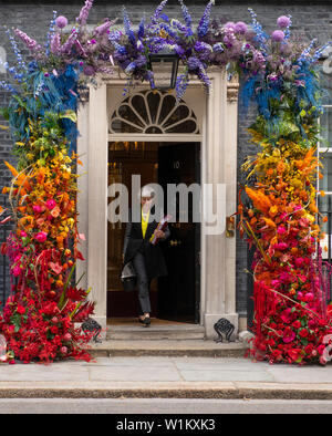 Downing Street, London, UK. 3rd July 2019. British Prime Minister leaves No 10 Downing Street to attend weekly Prime Ministers Questions in Parliament, with the entrance to No 10 decorated in rainbow coloured floral display to celebrate Pride. Pride in London parade takes place on Satuday 6th july. Credit: Malcolm Park/Alamy Live News. Stock Photo