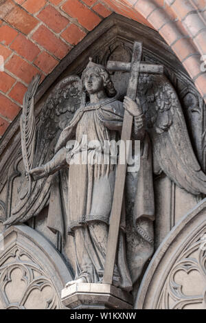 Detailed picture of the angel statue above the entrance of medieval Bad Doberan cathedral Stock Photo