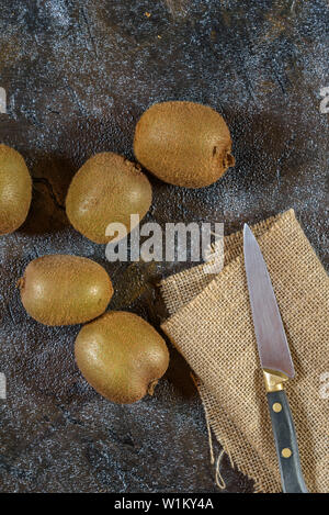 Kiwis on a dark rustic background Stock Photo