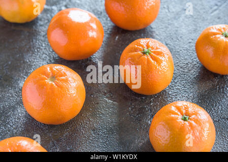 Tangerines on a dark rustic background Stock Photo