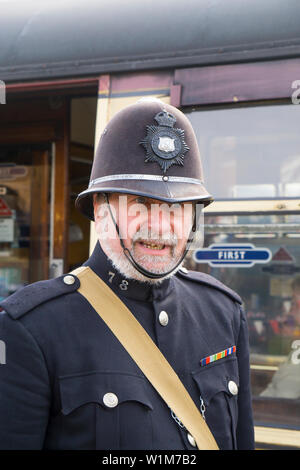 Close up of 1940s policeman in vintage police uniform & helmet sitting ...