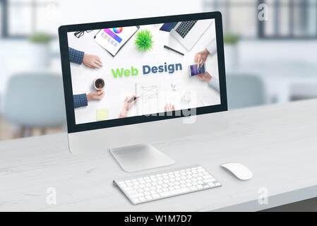 Web site design studio concept. Computer display with web design text. Stock Photo