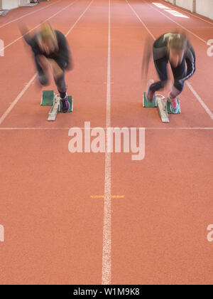 Two women runners on tartan track in starting position, Offenburg, Baden-Württemberg, Germany Stock Photo