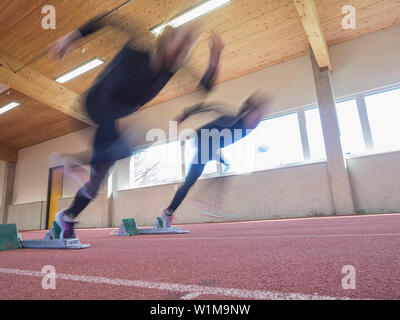 Two women runners in motion on tartan track, Offenburg, Baden-Württemberg, Germany Stock Photo