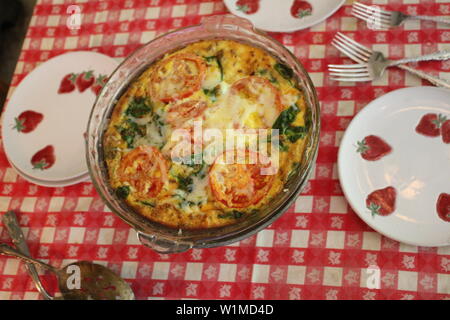 CHEESY FRITATA WITH SPINACH AND TOMATOES Stock Photo