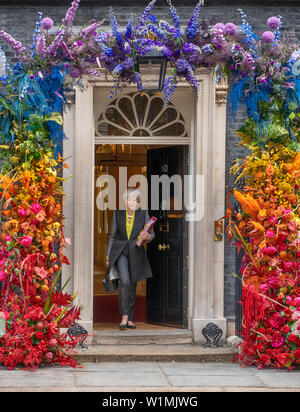 Downing Street, London, UK. 3rd July 2019. British Prime Minister leaves No 10 Downing Street to attend weekly Prime Ministers Questions in Parliament, with the entrance to No 10 decorated in rainbow coloured floral display to celebrate Pride. Pride in London parade takes place on Satuday 6th july. Credit: Malcolm Park/Alamy Live News. Stock Photo