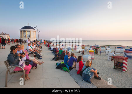 People on the beach promenade watching the sunset, Borkum, Ostfriesland, Lower Saxony, Germany Stock Photo