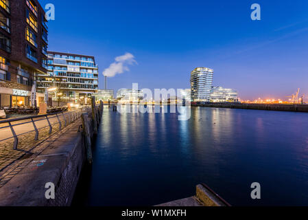 Modern architecture in the twilight, Am Kaiserkai, with view to the Grasbrook harbour and Marco-Polo-Tower, HafenCity, Hamburg, Germany Stock Photo