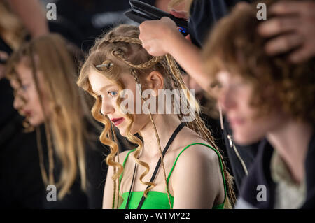 Berlin, Germany. 03rd July, 2019. Models get their hair styled by designer Lena Hoschek before the show. The collections for Spring/Summer 2019 will be presented at Berlin Fashion Week. Credit: Monika Skolimowska/dpa-Zentralbild/dpa/Alamy Live News Stock Photo