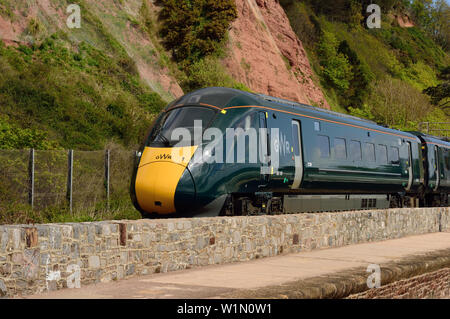 GWR Inter-city express train along the sea wall at Teignmouth, headed by power car No 802106, 4th May 2019. Stock Photo