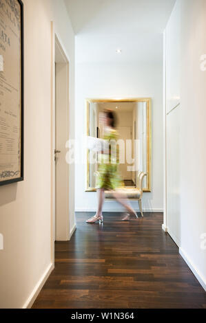 Woman passing a corridor, Hamburg, Germany Stock Photo