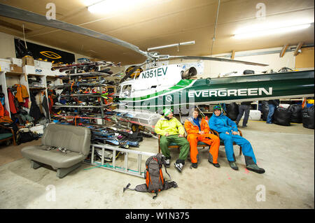 Heliskier sitting inside a hangar, Chugach Powder Guides, Girdwood, Alaska, USA Stock Photo