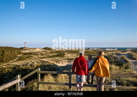 Familiy watching lighthouse, Amrum island, Schleswig-Holstein, Germany Stock Photo