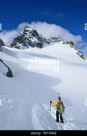 Female back-country skier ascending to Piz Kesch, Engadin, Canton of Graubuenden, Switzerland Stock Photo