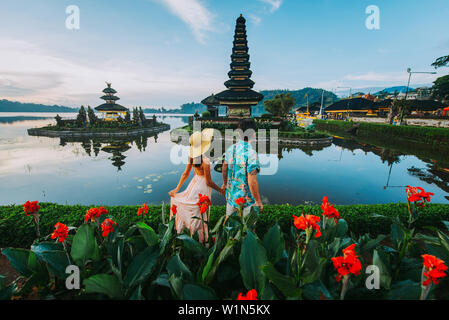 Couple spending time at the ulun datu bratan temple in Bali. Concept about exotic lifestyle wanderlust traveling Stock Photo