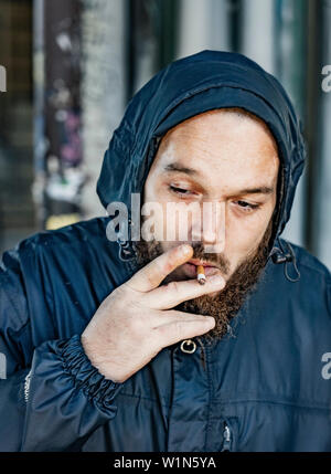 street portrait of a middle aged man in Philadelphia smoking Stock Photo