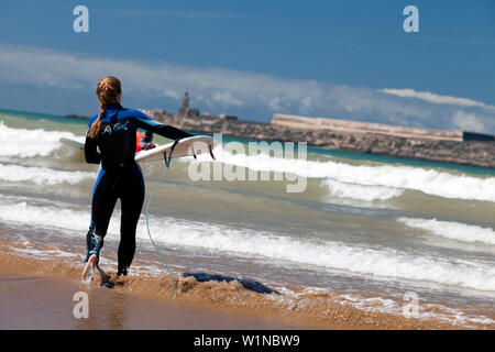 Surfer on the beach, Essaouira, Morocco Stock Photo