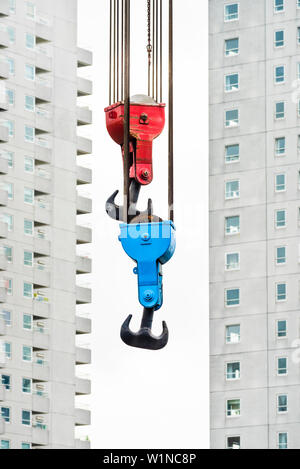 The hooks of an old crane in the Leuvehaven in front of the scenery of residential high rise buildings, Rotterdam, the Netherlands Stock Photo