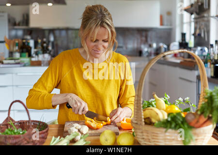 Woman cutting vegetables in the kitchen Stock Photo