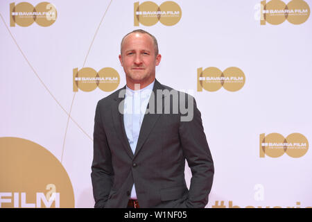 02 July 2019, Bavaria, Munich: The actor Maximilian Brückner stands at the reception of the Bavaria Film on the Red Carpet at the Filmfest Munich which takes place from 27.06.2019 to 06.07.2019. Photo: Felix Hörhager/dpa Stock Photo