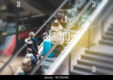 People on escalator in train station, travel concept motion blur Stock Photo