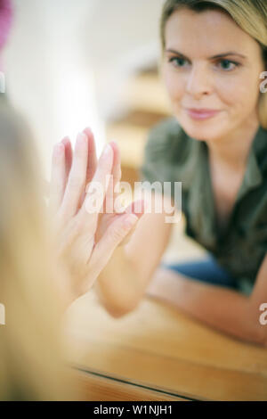 Young woman looking into the mirror, reflected in the mirror Stock Photo
