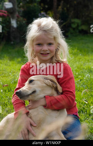 Girl with golden retriever dog in rainy day Stock Photo - Alamy