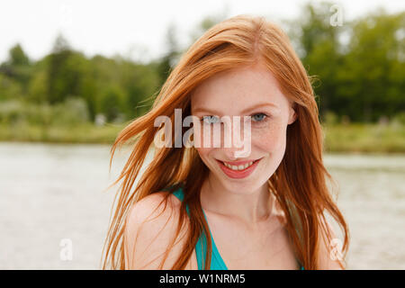 Young woman smiling at camera, Munich, Bavaria, Germany Stock Photo