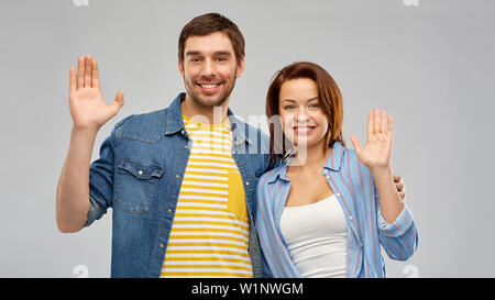happy couple waving hands Stock Photo