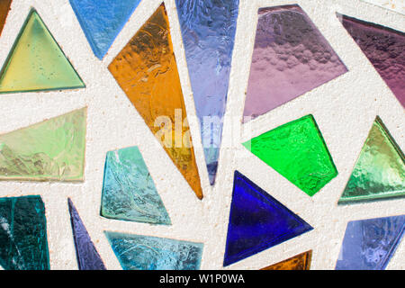 Mosaic surface made of multi-colored glass. Abstract mosaic glass tiles patterned background. CLose up. Stock Photo