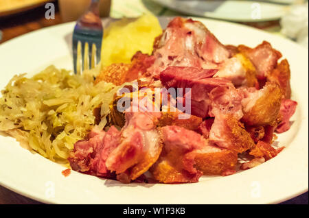 German pork fried with vegetables on a white plate Stock Photo