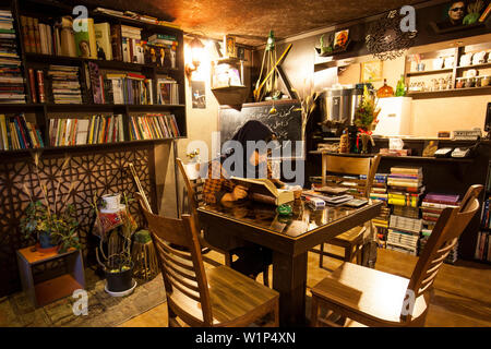 Reading woman in cafe, Esfahan, Iran, Asia Stock Photo