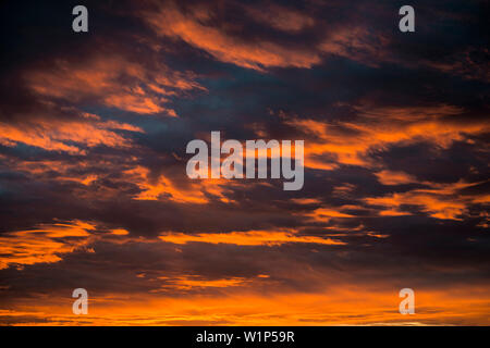 Sunset with red illuminated clouds Stock Photo
