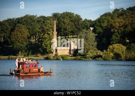 group of people in swimsuits relax at motorized float, view from Glienicke Bridge at royal garden of Babelsberg, Potsdam, Brandenburg, Germany Stock Photo