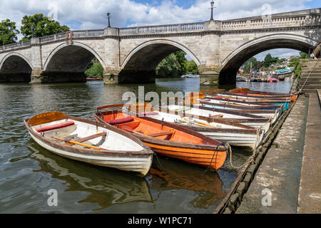 LONDON, UK - JULY 02, 2019. Wooden boats of Richmond Bridge Boat Hire company moored on the River Thames, Richmond, Surrey, England Stock Photo