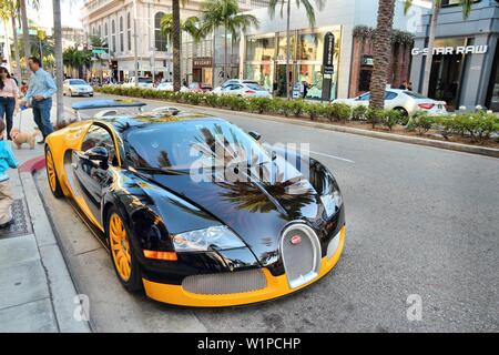 LOS ANGELES, USA - APRIL 5, 2014: People walk by Bugatti Veyron supercar parked in Beverly Hills, Los Angeles. Beverly Hills is a district of upscale Stock Photo