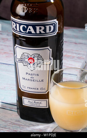 A bottle of Ricard, the french aperitif, titled Pastis de Marseille, and a glass of Ricard diluted with water Stock Photo